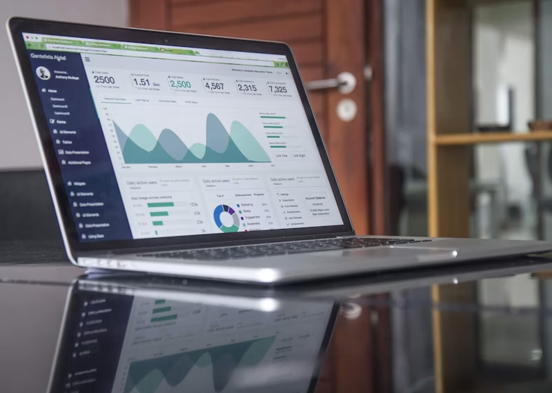 Laptop displaying analytics dashboard with graphs and data metrics, illustrating AI automation solutions for business productivity and lead generation.